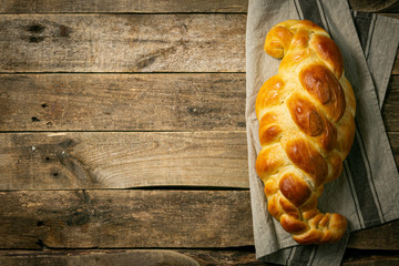 Traditional jewish bread challah on wood background, top view