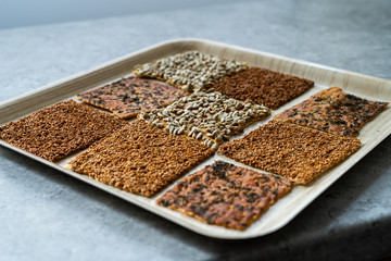 Turkish Homemade Snacks Biscuit with Sunflower Seeds, Sesame and Dill /Crispy Yaprak Galeta with Traditional Tea on Tray.