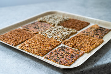 Turkish Homemade Snacks Biscuit with Sunflower Seeds, Sesame and Dill /Crispy Yaprak Galeta with Traditional Tea on Tray.