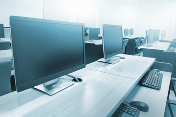 Fototapeta na wymiar Monitors on the table in computer laboratory or training room