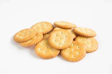Crispy cookies or crackers on white background.