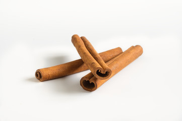Cinnamon sticks aromatic condiment on white.