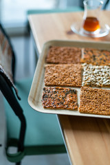 Turkish Homemade Snacks Biscuit with Sunflower Seeds, Sesame and Dill /Crispy Yaprak Galeta with Traditional Tea on Tray.