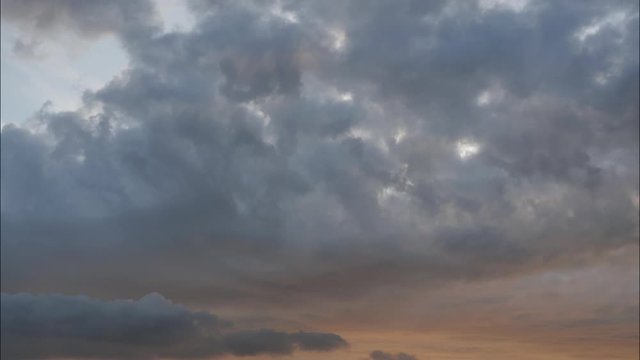 Time lapse  Cumulonimbus clouds on tropical blue sky at sunrise, The horizon began to turn orange with purple and gray cloud at morning, Dramatic cloudscape area