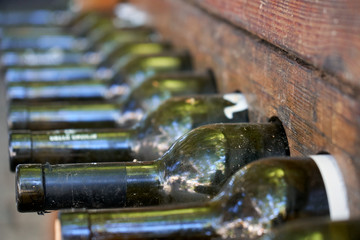 Wine bottles stacked in the special wooden racks. Storage of wine