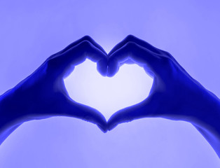 Hands in the form of heart blue shades background. heart symbol with hand. valentines day card....