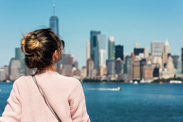 Woman in pink sweater posing on the background of New York city
