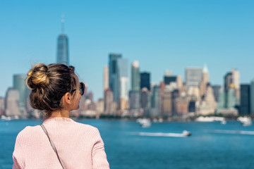 Woman in pink sweater posing on the background of New York city