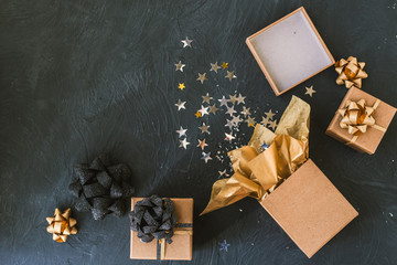 Christmas gifts on a black background. Open gift with stars.