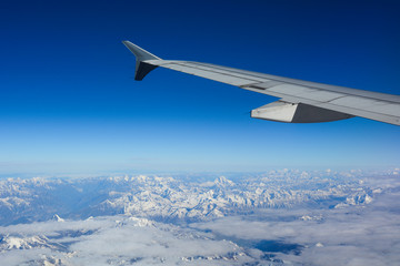 Obraz premium View from airplane to mountains and clouds