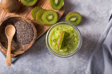 Healthy vegan chia pudding in a glass with fresh kiwi. Organic food concept
