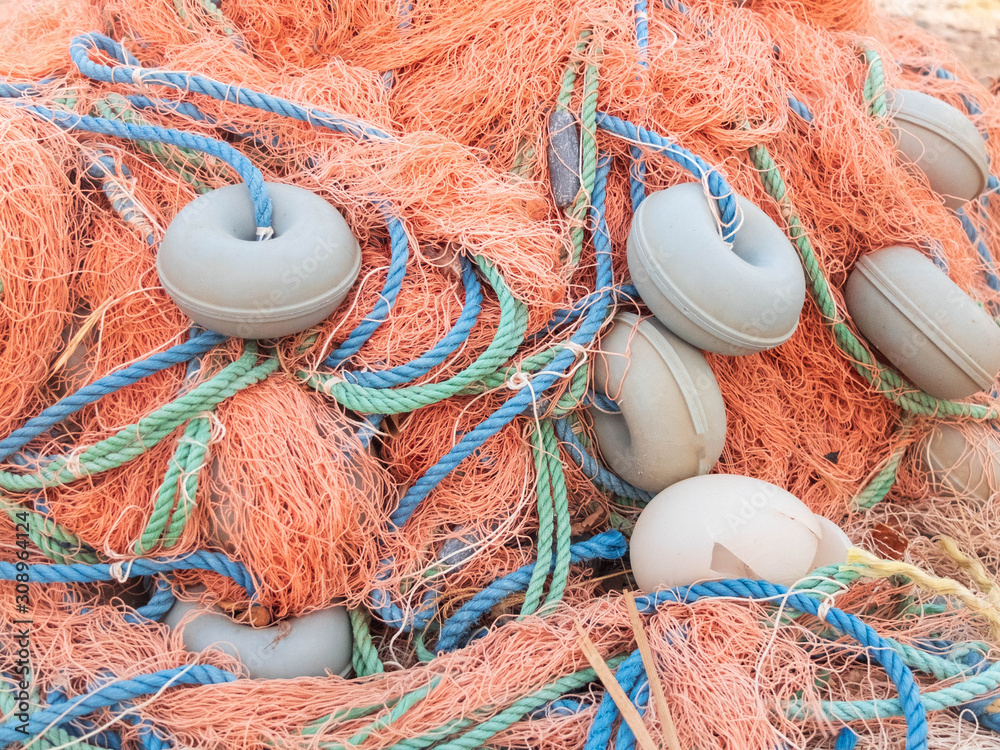 Wall mural old tangle colorful fisherman net with floaters