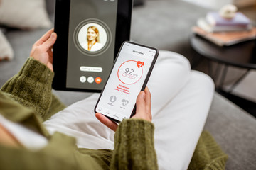 Woman making video call to a doctor using digital tablet, feeling bad with high heart beat at home....