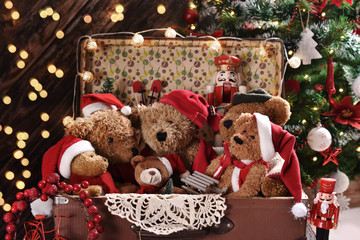 old suitcase full of teddy bears in Santa caps
