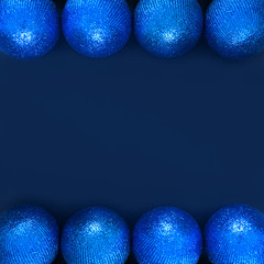 Christmas composition with copy space. New year balls or bubles blue decorations on paper blue background. Christmas, winter, concept. Flat lay, top view.