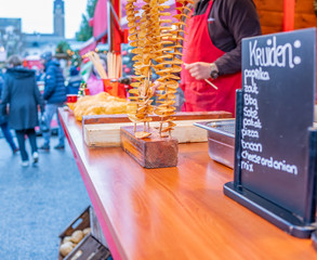 Selective focus on fried crisps on skewers at the 2019 Christmas market in Maastricht, Netherlands