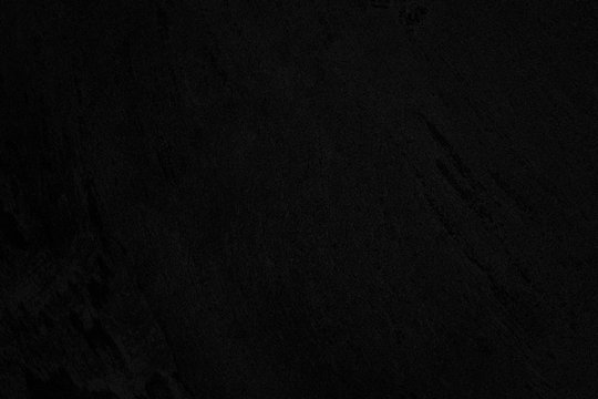 Black low contrast concrete textured wall background with roughness and irregularities to your concept or product. © Aleksandra Konoplya