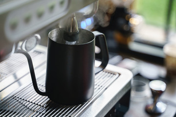 Pouring hot water from coffee blending machine
