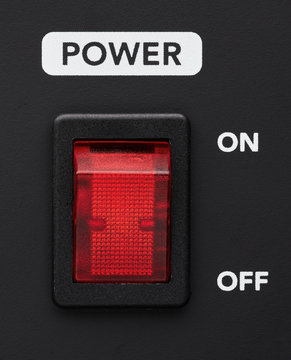 Power on and off electrical switch red button on black background