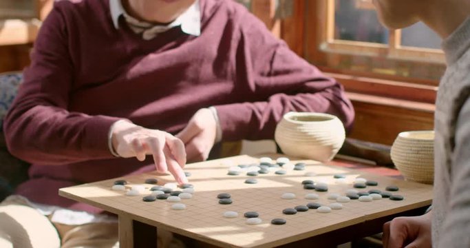 Happy father and son playing the game of go,4K