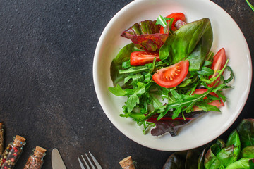 Healthy salad, leaves mix salad (mix micro greens, tomato, onion, other ingredients). food background. copy space