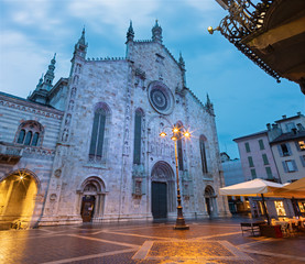 Como - The portal of Duomo at dusk.