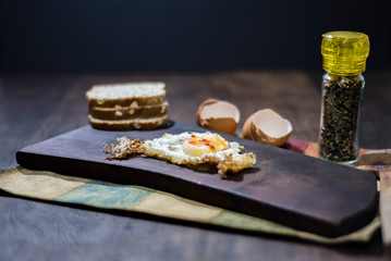 Spiced scrambled fried eggs on wooden board