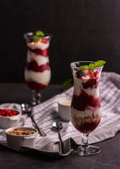 Exposition of fresh organic and nature smoothie. Tasty and healthy desert on black background.
