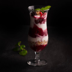 Exposition of fresh organic and nature smoothie. Tasty and healthy desert on black background.
