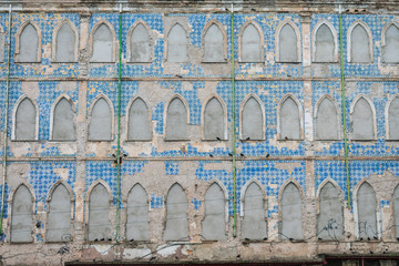 Historical building with Portuguese tiles abandoned and with windows shut closed with cement next...