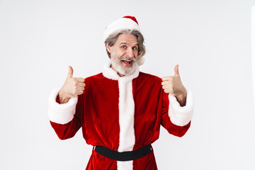 Fototapeta na wymiar Image of Santa Claus old man in red costume gesturing thumbs up