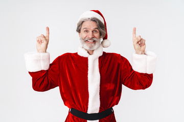 Fototapeta na wymiar Image of Santa Claus man in red costume pointing fingers at copyspace