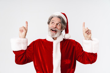 Image of Santa Claus old man in red costume pointing fingers upward