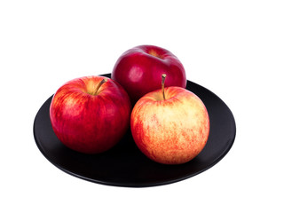 Perfect three red apples on black plate isolated on white background. Juicy and fresh apples for ads