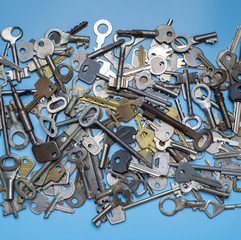 Keys set on blue background. Door lock keys and safes for property security and house protection....