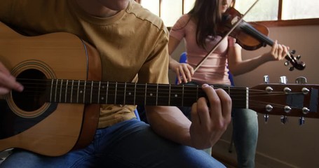 Teenage musicians rehearsing