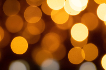defocus of yellow and white bokeh in black background for wallpaper 