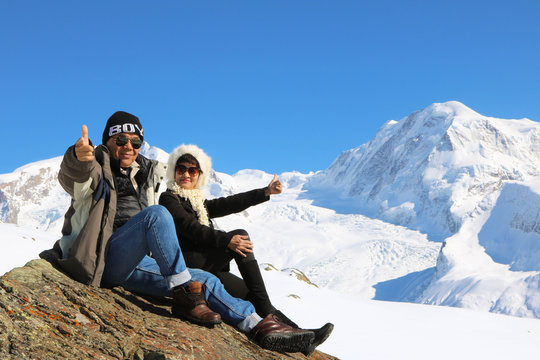 Asian Senior Couple Posing With Mountain Matternhorn In Winter Season And Blue Sky