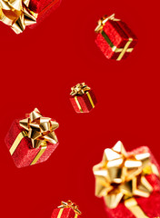 Gifts are flying in the air on a red background. Sale. Levitation concept. Christmas layout.