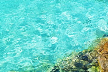 Fototapeta na wymiar Turquoise water and rocks of Miami beach pier