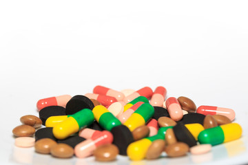 Various pills and capsules on white background closeup view