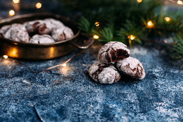 Chocolate Crinkle Cookies on a blue table. New Year, Christmas