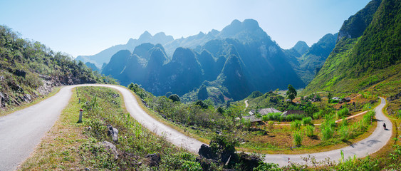 Ha Giang karst geopark mountain landscape in North Vietnam. Winding road in stunning scenery. Ha Giang motorbike loop, famous travel destination bikers easy riders.
