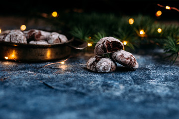 Chocolate Crinkle Cookies on a blue table. New Year, Christmas