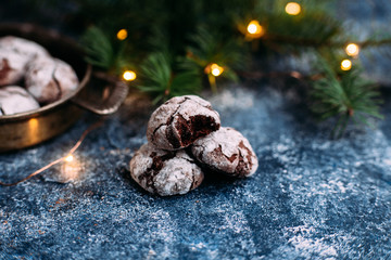 Chocolate Crinkle Cookies on a blue table. New Year, Christmas