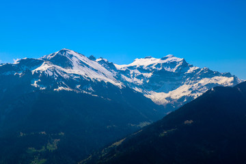 Fototapeta premium Swiss alps with blue sky from Harder klum in sunny day, Switzerland. Snow mountain.