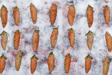 Pattern of fresh fir cones with green needles on snow, abstract winter, new year background