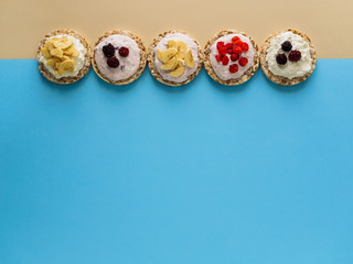 A sweet Breakfast of Crispbread, cottage cheese and fruit on a colored background. Copy space