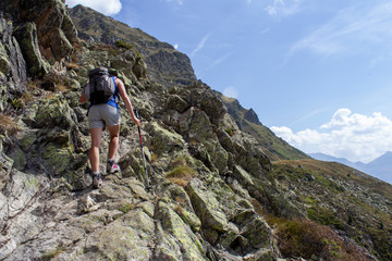 hiker climbing steep rocks in the Pyrenees