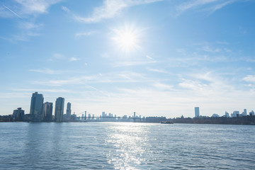 Sun Shining over the East River between Brooklyn and Manhattan New York with the Williamsburg Bridge